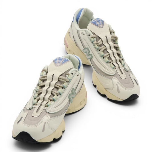 urbanstyle New Balance 1000 sneakers in off-white with pastel blue, green, and pink accents, featuring mesh and synthetic layers.