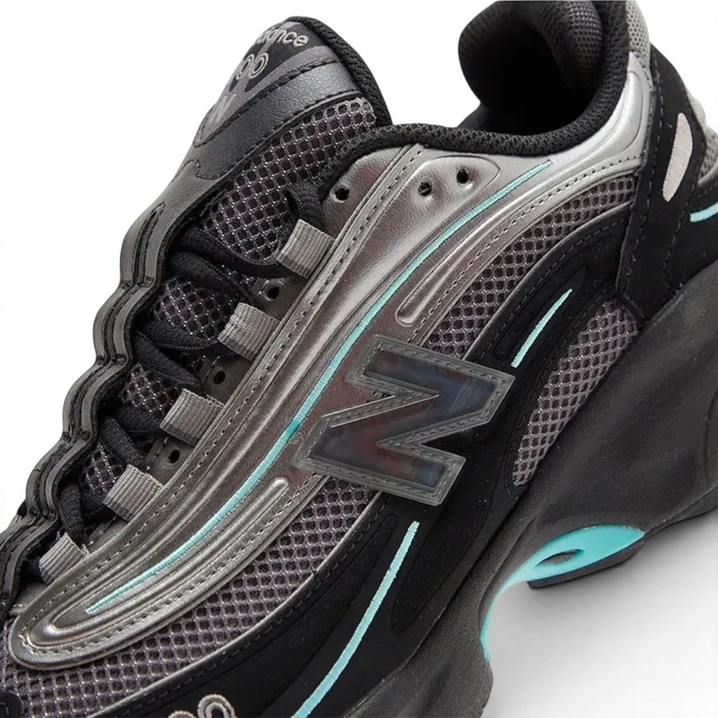 urbanstyle New Balance 1000 lifestyle sneakers in black and metallic silver with teal accents and mesh upper.