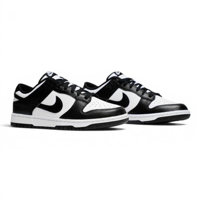 Urbanstyle black and white leather low-top sneakers with Nike Swoosh branding and white rubber soles.