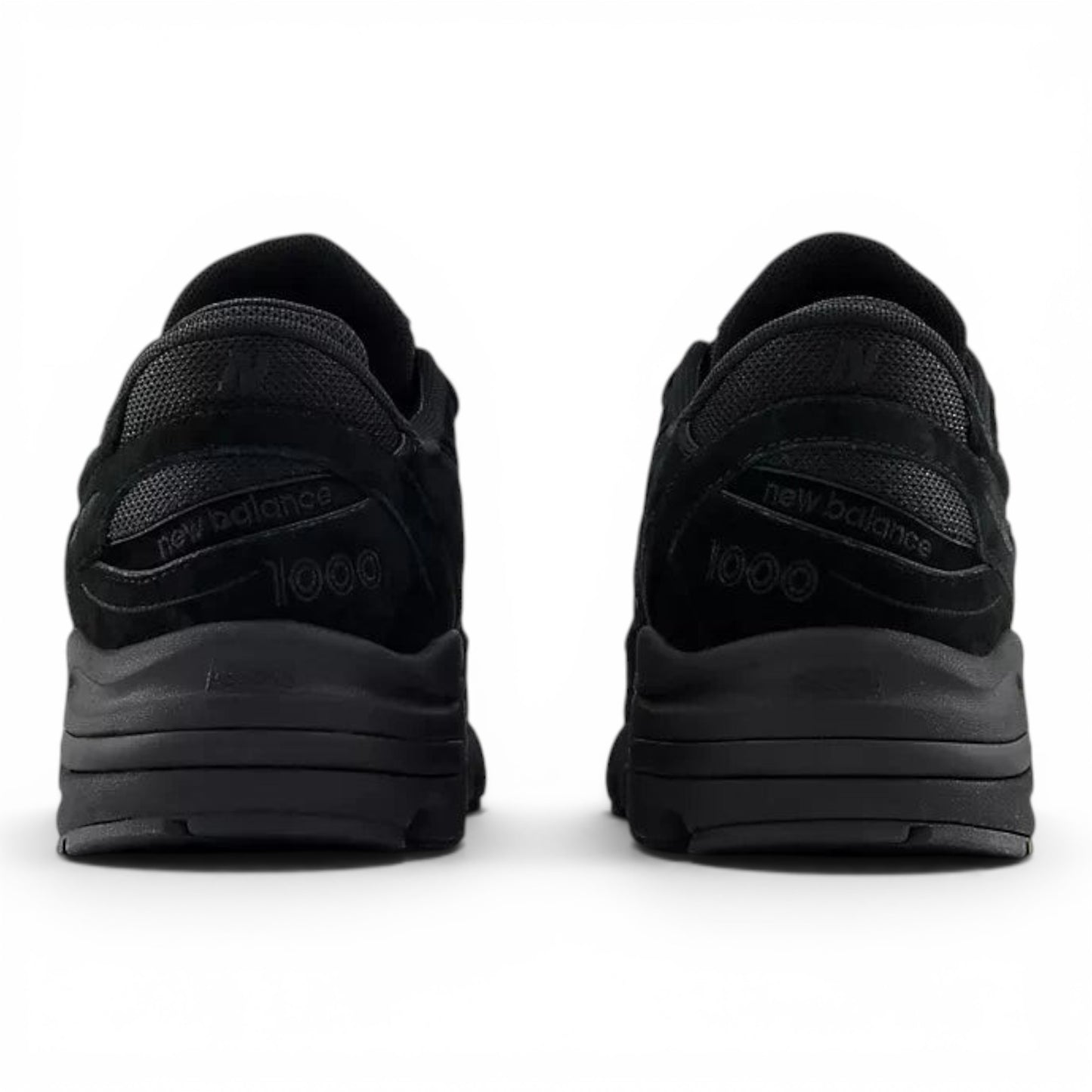 urbanstyle New Balance 1000 black lifestyle sneakers featuring suede and mesh details from a rear view.