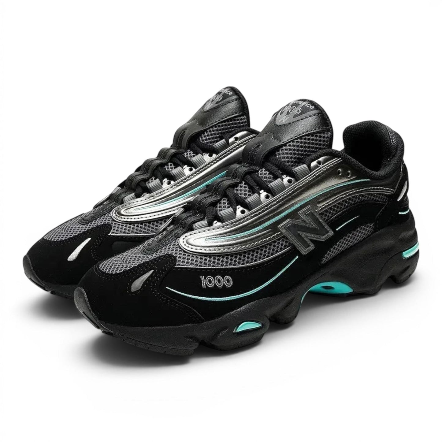 urbanstyle New Balance 1000 sneakers in black and metallic silver with teal accents, featuring mesh and suede layers.