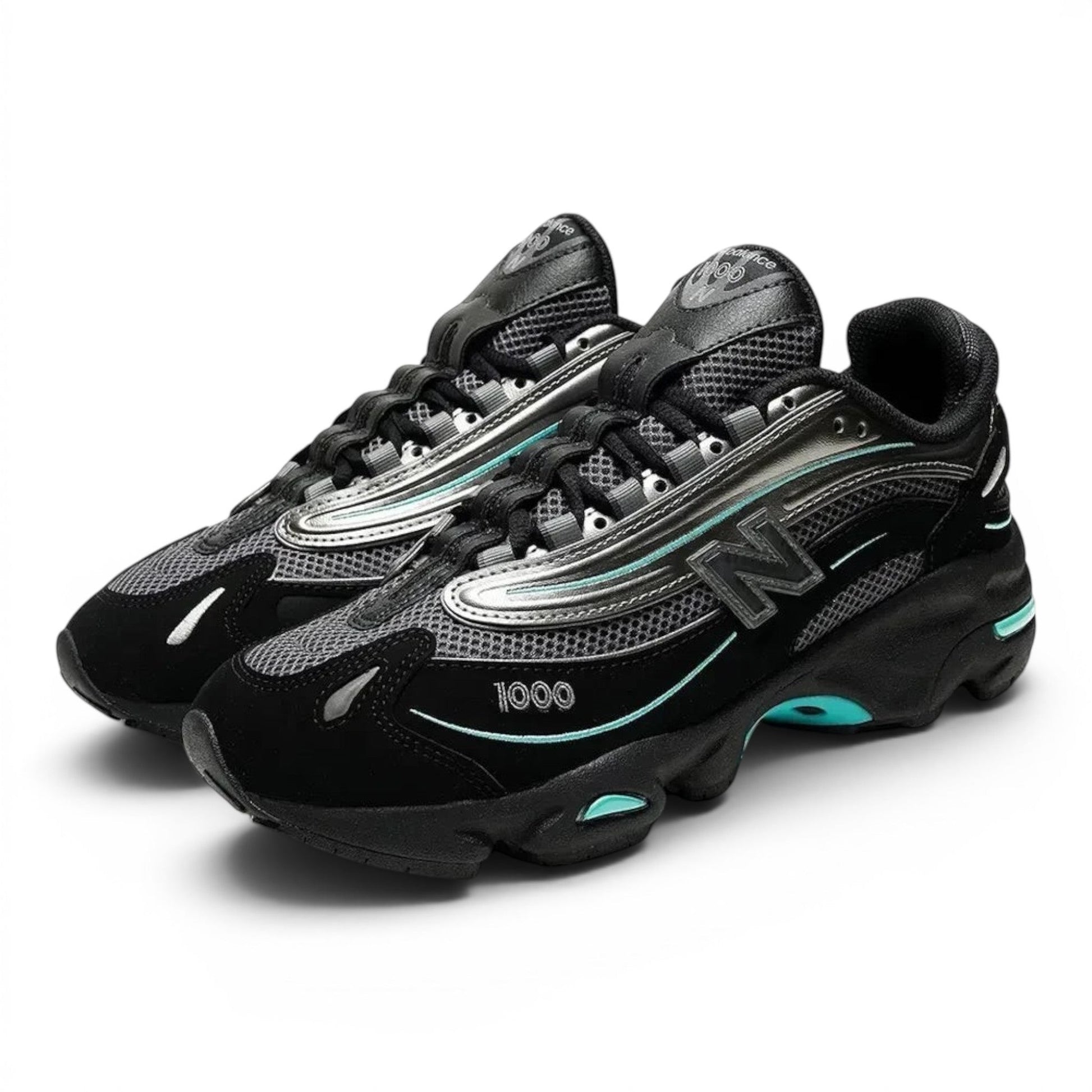urbanstyle New Balance 1000 sneakers in black and metallic silver with teal accents, featuring mesh and suede layers.