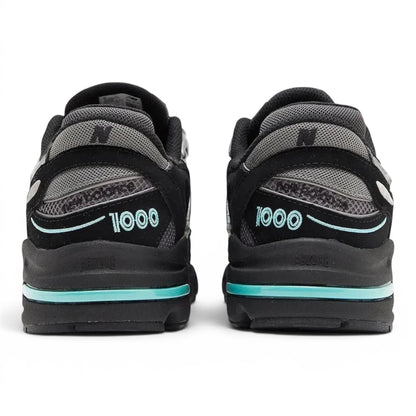 urbanstyle New Balance 1000 sneakers in black and silver with teal accents, showing the rear view and chunky midsole.
