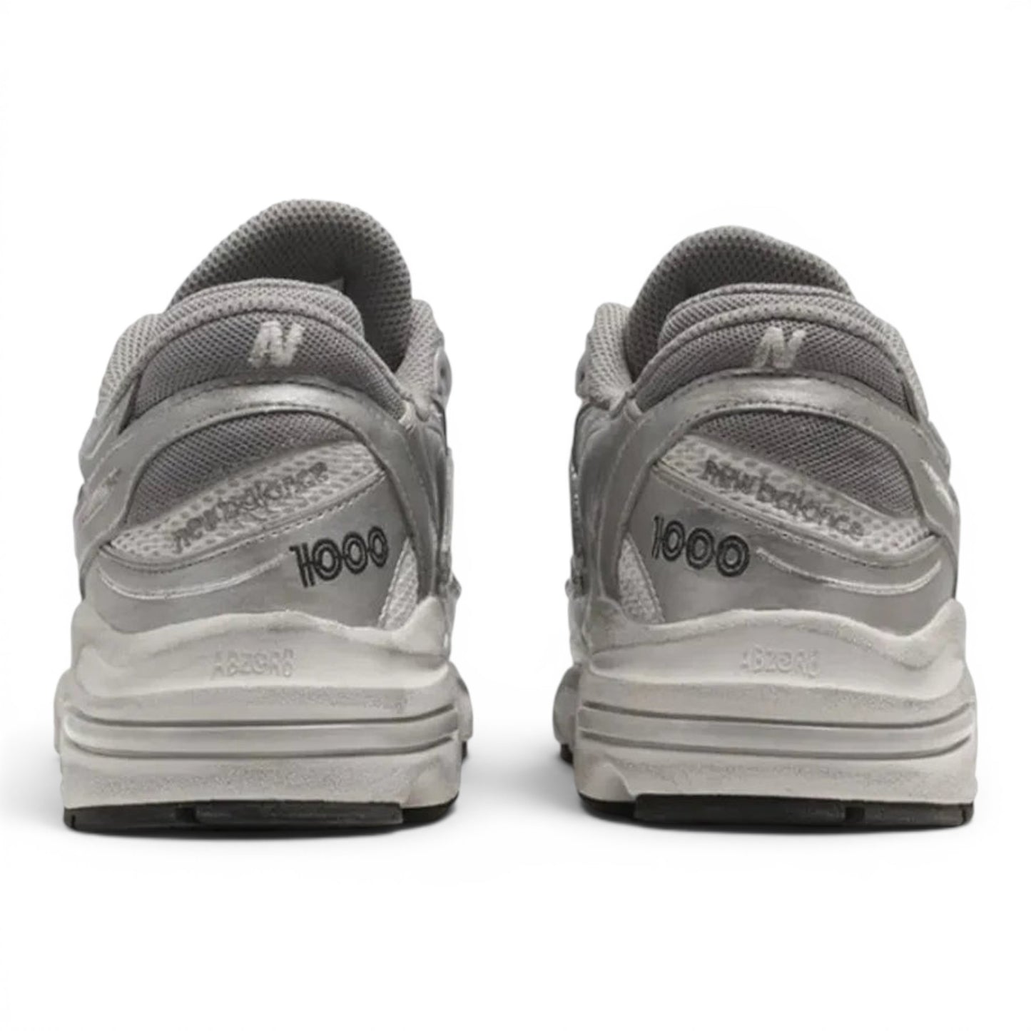 Rear view of metallic silver New Balance 1000 lifestyle sneakers from urbanstyle with ABZORB cushioning and mesh upper.