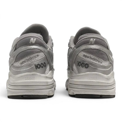 Rear view of metallic silver New Balance 1000 lifestyle sneakers from urbanstyle with ABZORB cushioning and mesh upper.