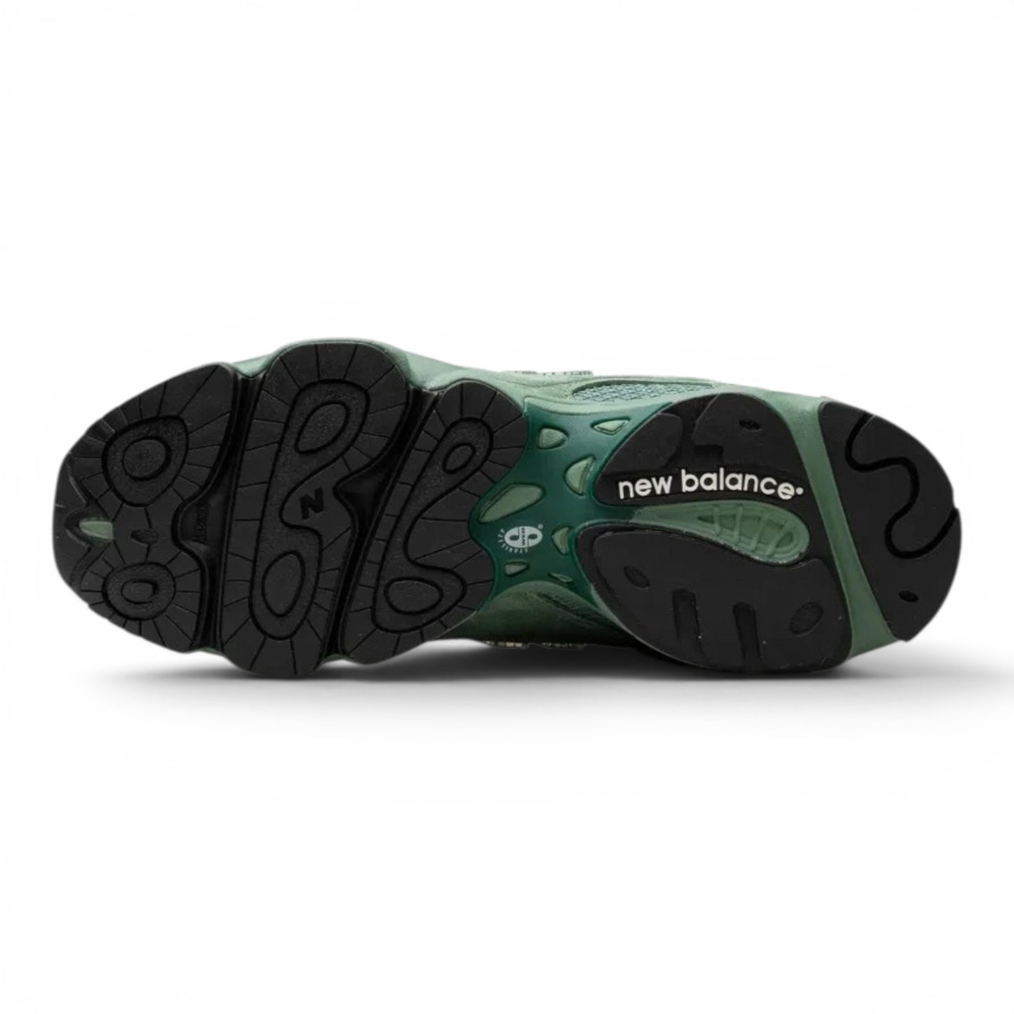 urbanstyle New Balance 1000 sneaker showing the rugged black rubber outsole and sage green technical midsole design.