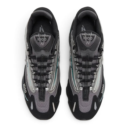 urbanstyle New Balance 1000 lifestyle sneakers in black and metallic silver with teal accents and mesh upper.