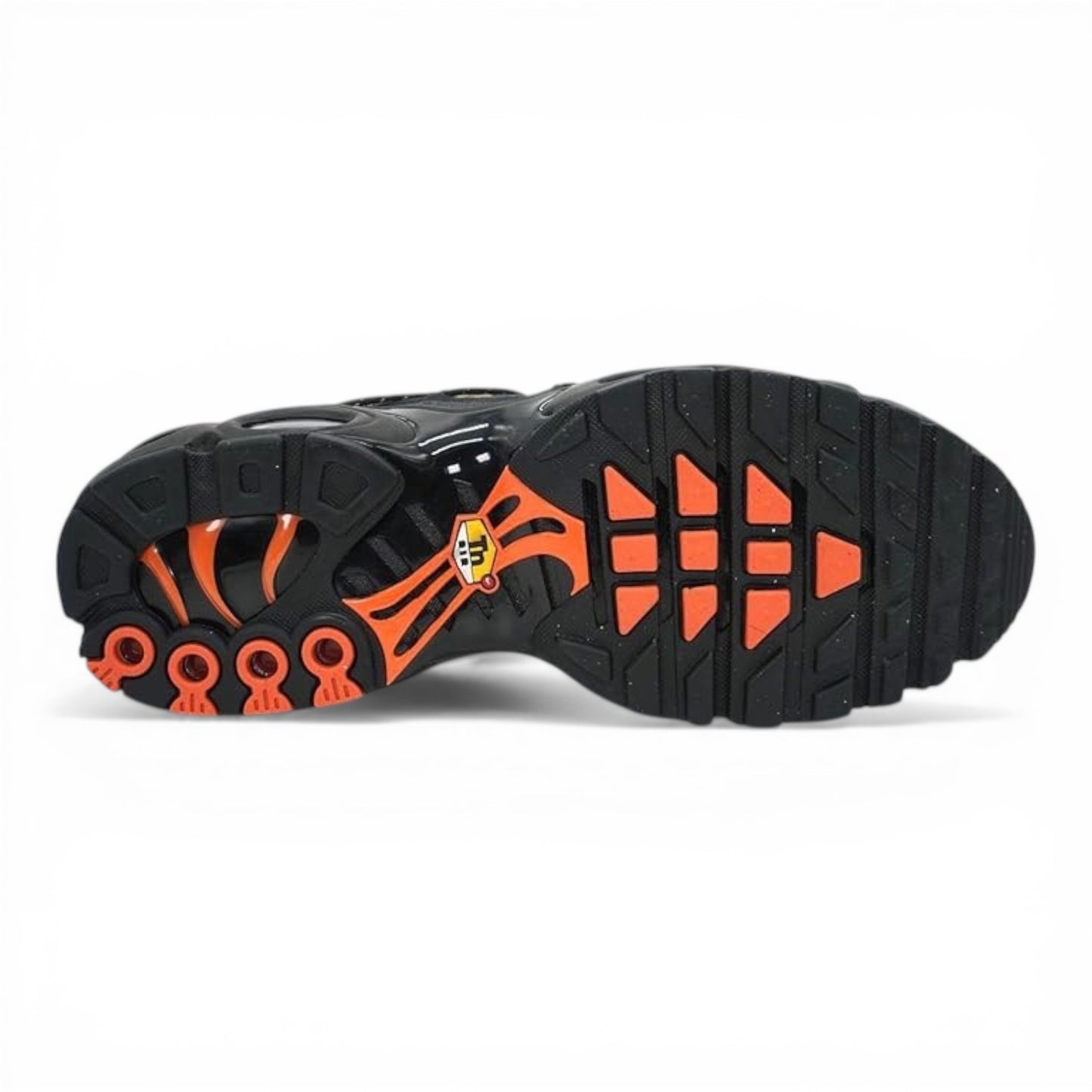 Nike Air Max Plus sneakers with black sole, orange accents, and tiger-stripe pattern. Tuned Air cushioning.
