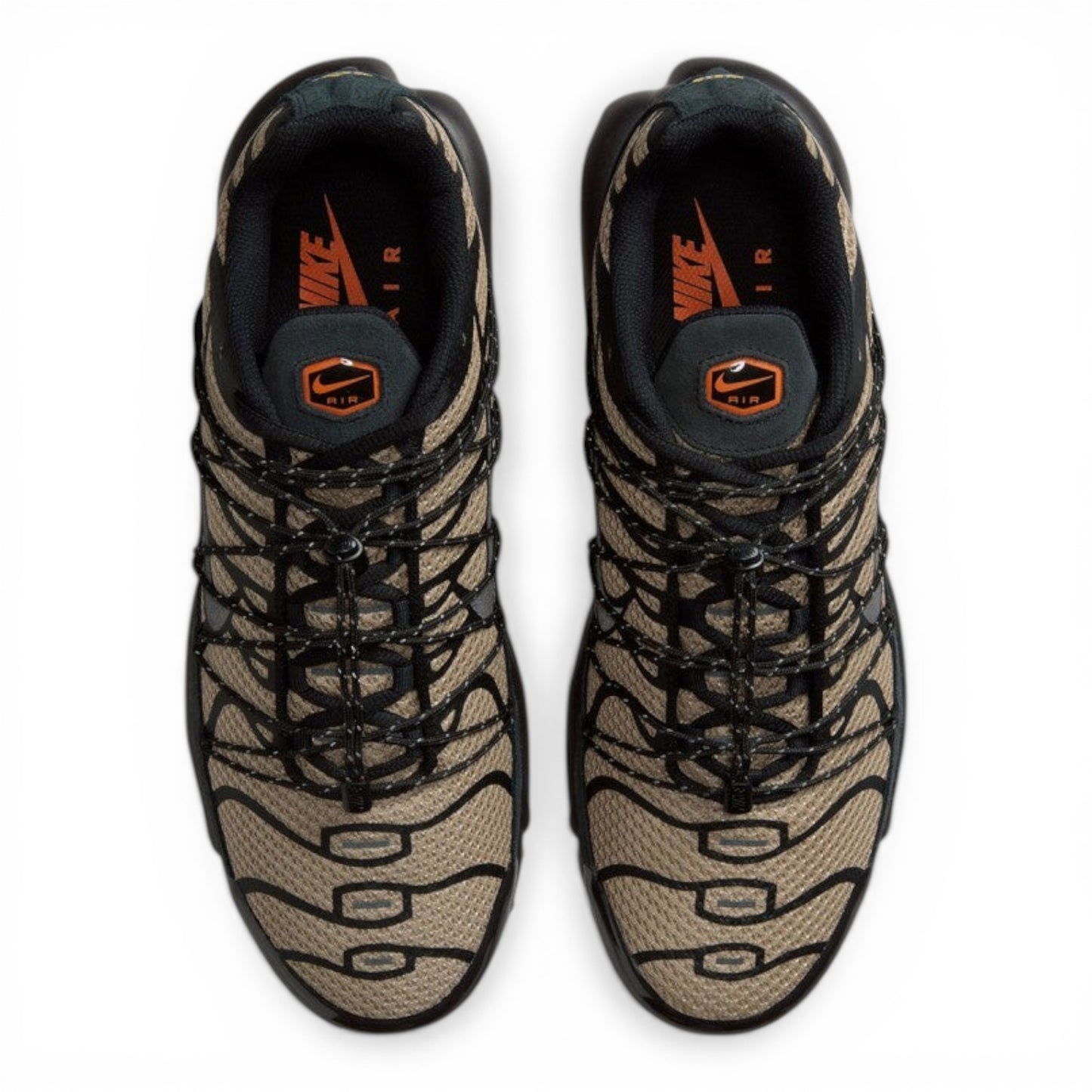 Nike Air Max Plus sneakers in tan and black tiger stripe mesh with black synthetic overlays and laces. Tuned Air cushioning.