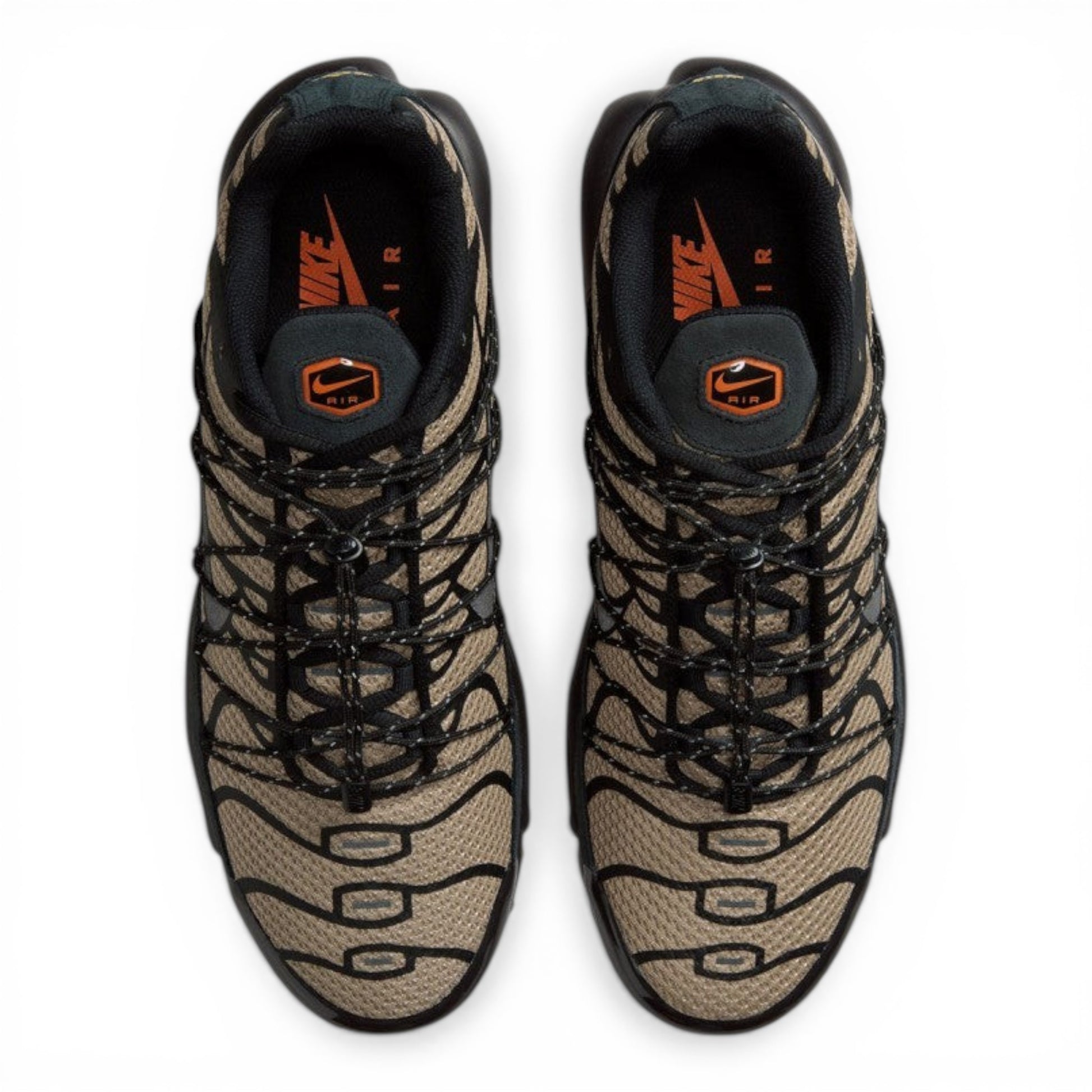 Nike Air Max Plus sneakers in tan and black tiger stripe mesh with black synthetic overlays and laces. Tuned Air cushioning.