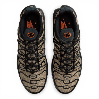 Nike Air Max Plus sneakers in tan and black tiger stripe mesh with black synthetic overlays and laces. Tuned Air cushioning.