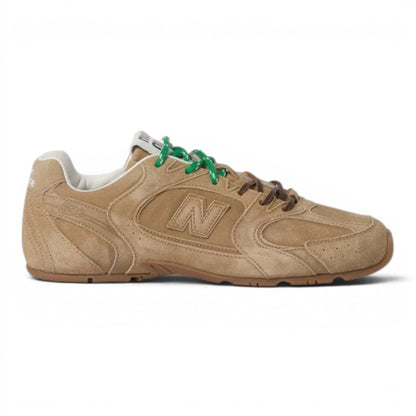 Urbanstyle tan suede low-top athletic sneakers with green and brown laces and a rubber sole.