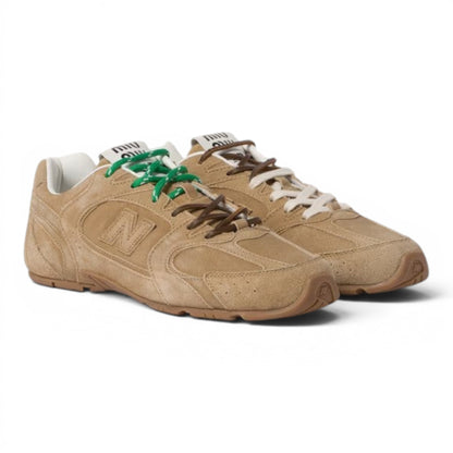 Urbanstyle tan suede low-top athletic sneakers with contrasting green and brown laces, rubber sole, and N logo.